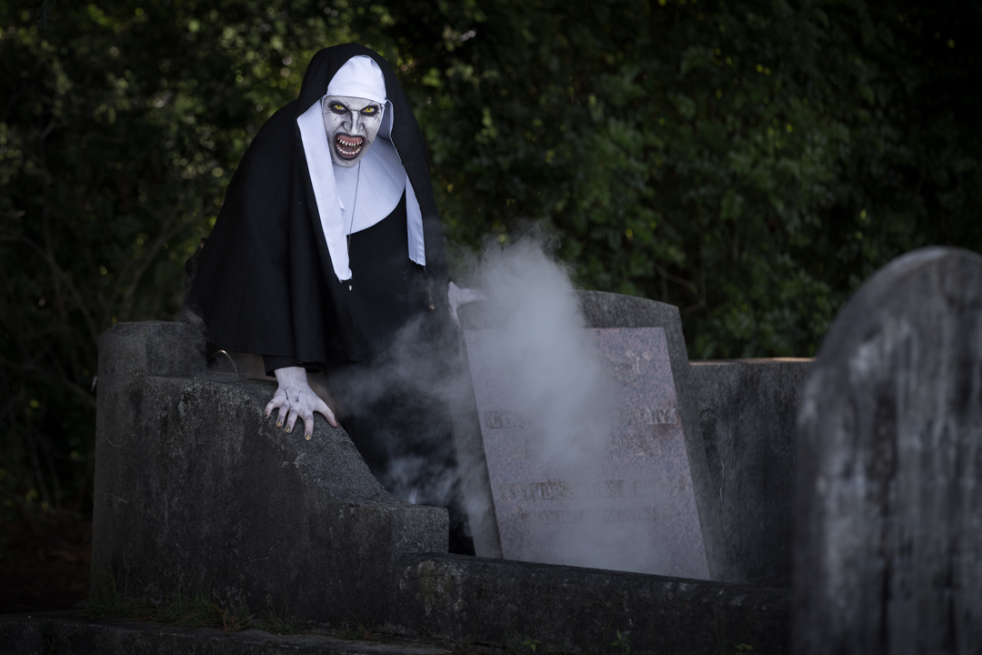 The Nun in the mist in a cemetery 