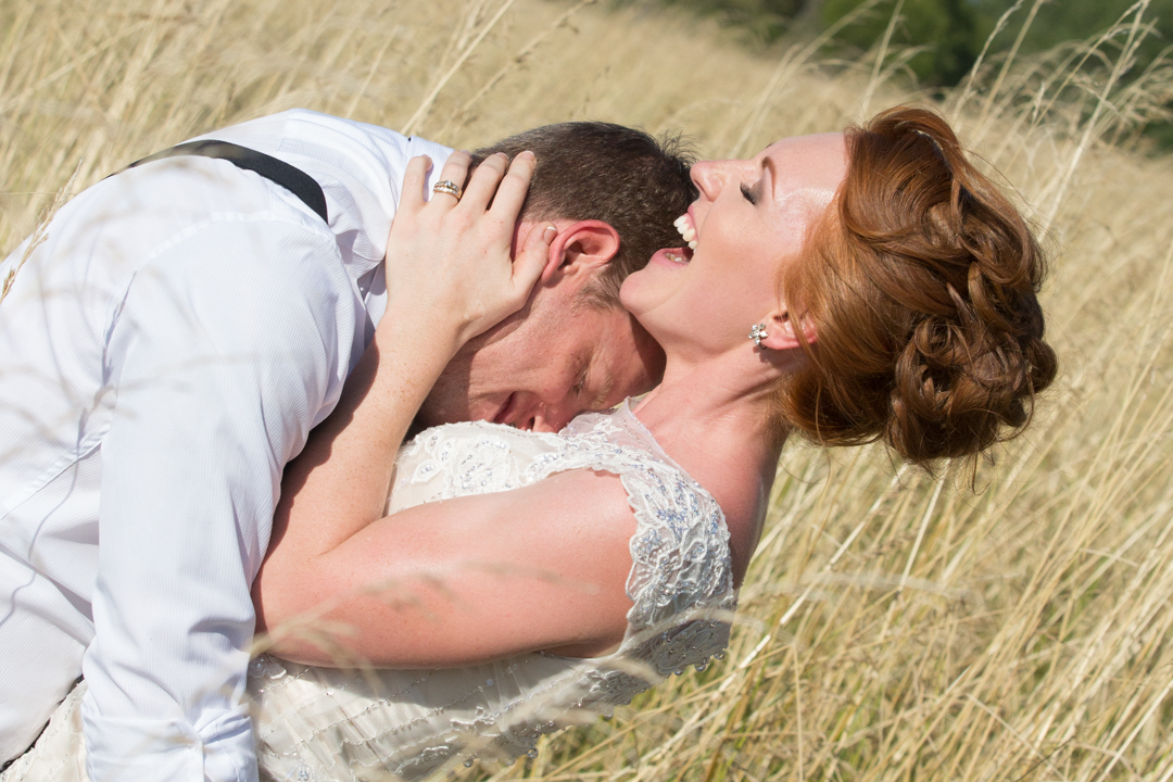 Groom kissing bride in the chest Te Puke