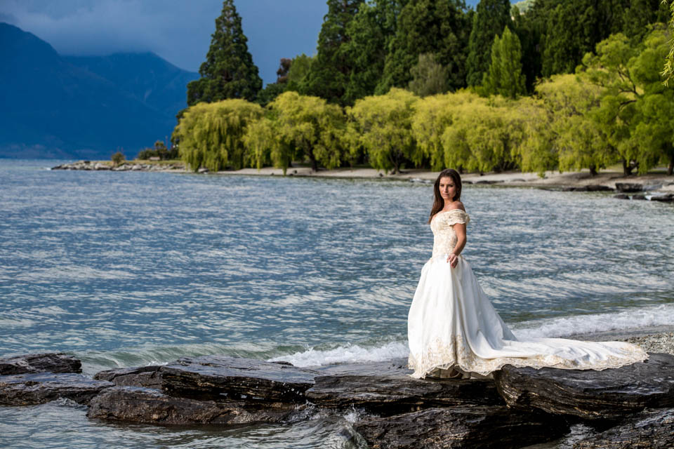 bride walking along the beach on Lake Wakatipu