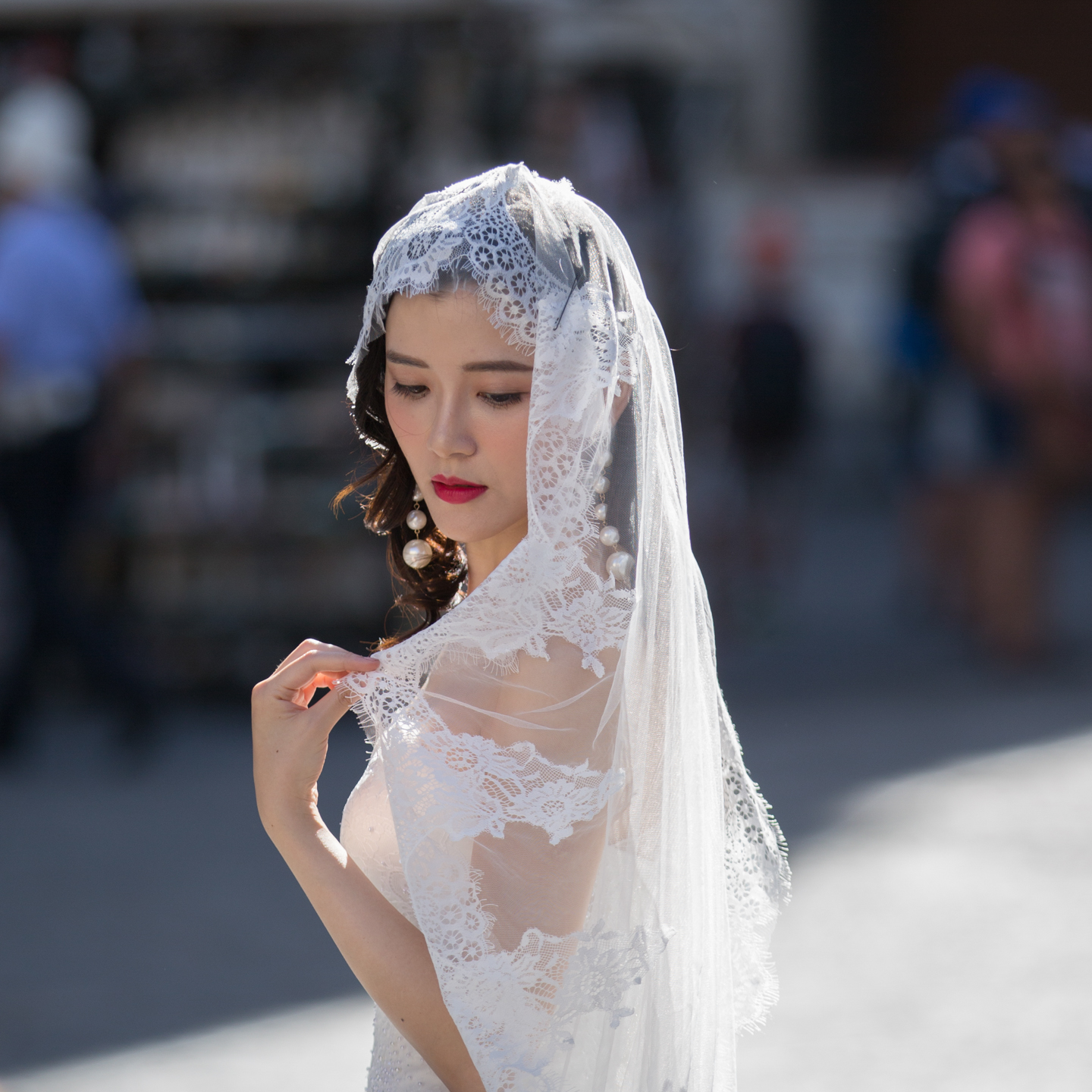 gorgeous bride in Venice adjusting her veil